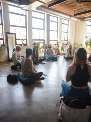 Photo by Dillon Wanner a group of people sitting on the floor in a room