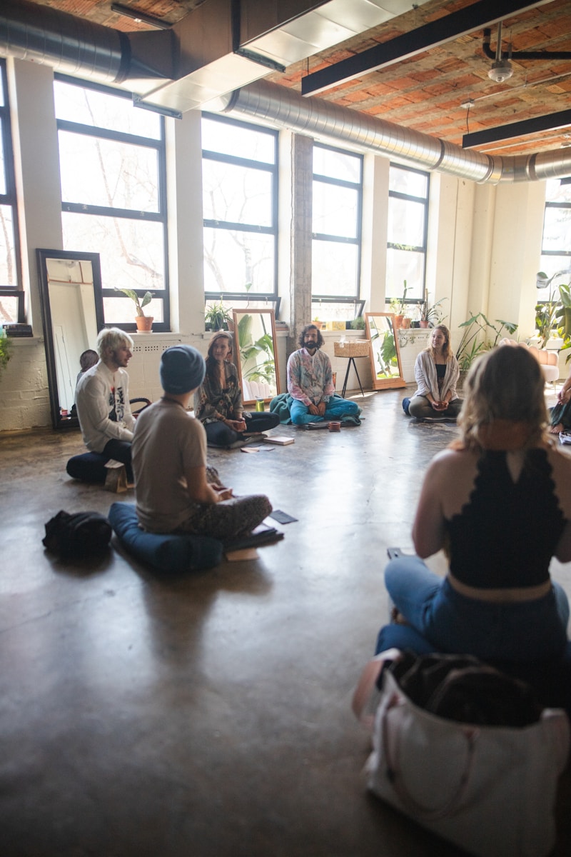 Photo by Dillon Wanner a group of people sitting on the floor in a room